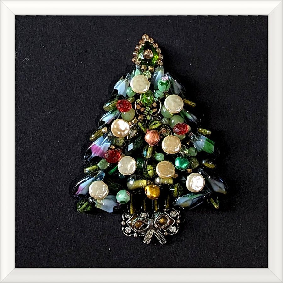 Holiday tree jewelry art in a white frame